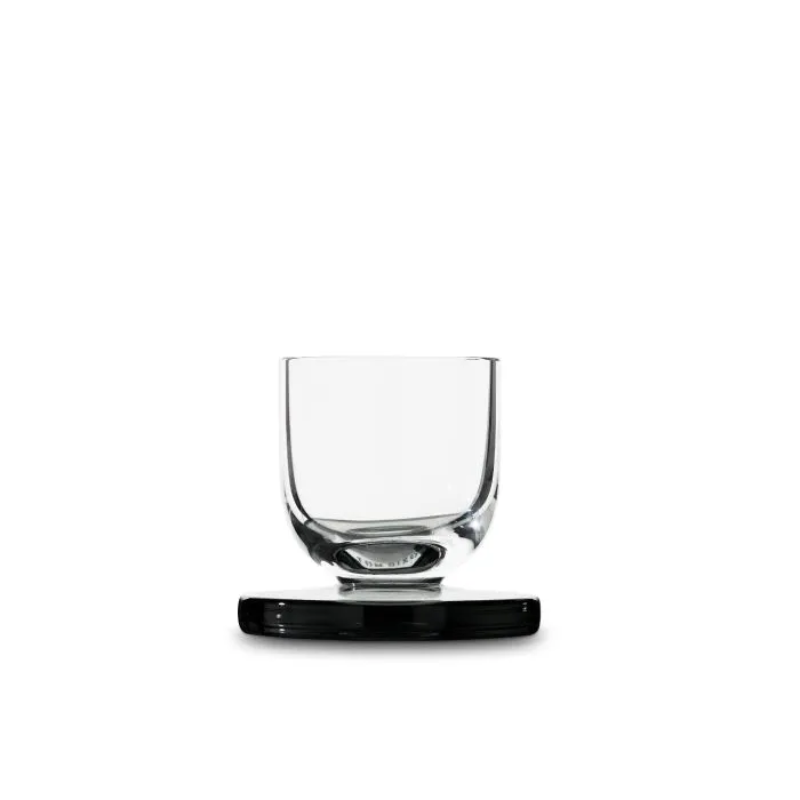 A Puck Shot Glass from Tom Dixon, empty.