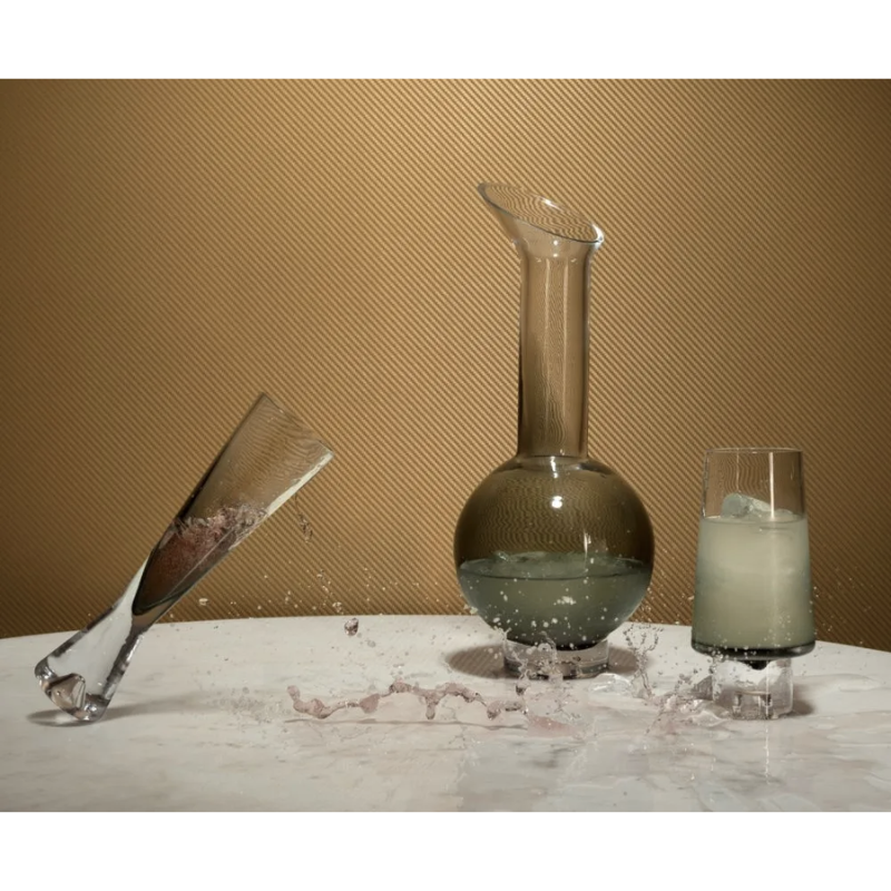The Tom Dixon Tank Champagne Glass in black with other Tank barware being used for drinks.