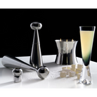 The Tank Champagne Glass in black from Tom Dixon among various other decorative items.