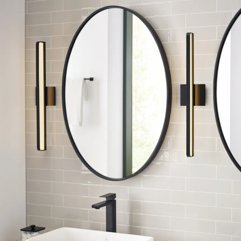 The Banda Bathroom Sconce from Visual Comfort & Co. in a bathroom lifestyle photograph.