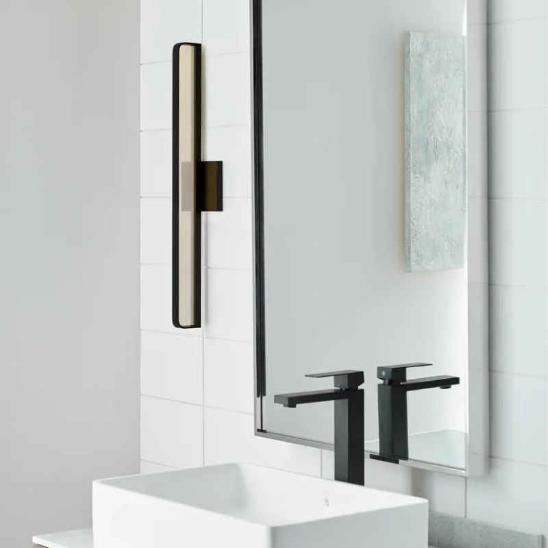 The Banda Bathroom Sconce from Visual Comfort & Co. in a washroom.