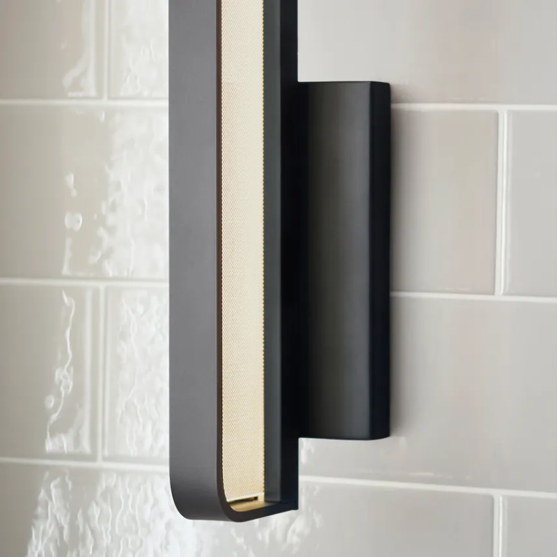 The Banda Vertical Wall Sconce from Visual Comfort & Co. in a washroom.