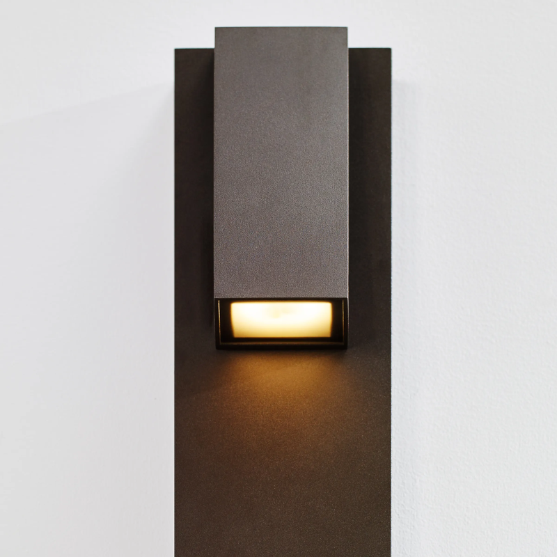 The Peak Outdoor Wall Sconce from Visual Comfort and Co in a close up lifestyle photograph.