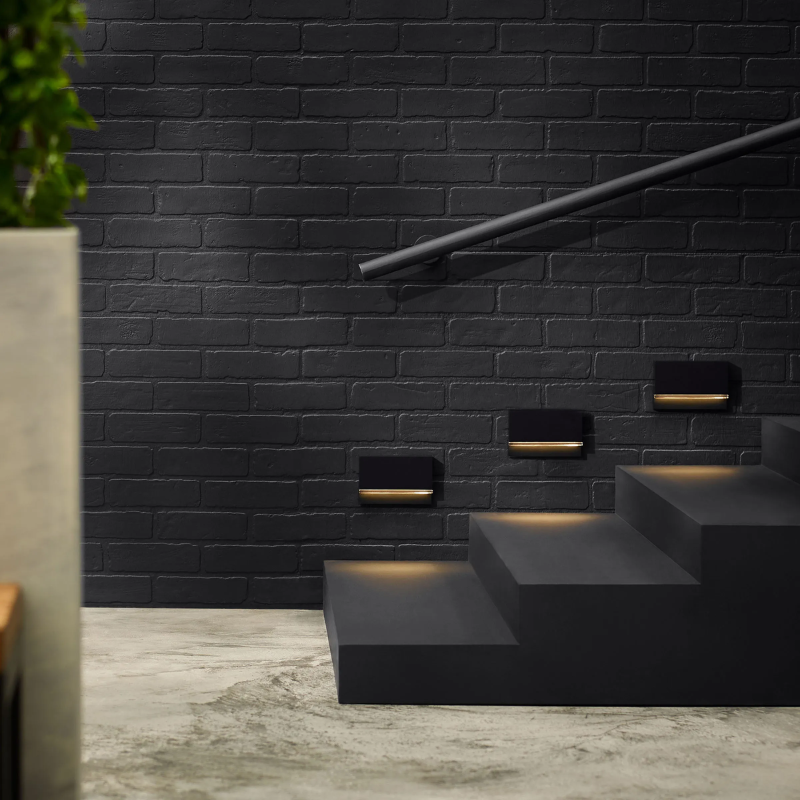 The Wend Outdoor Step Light from Visual Comfort and Co illuminating a staircase.
