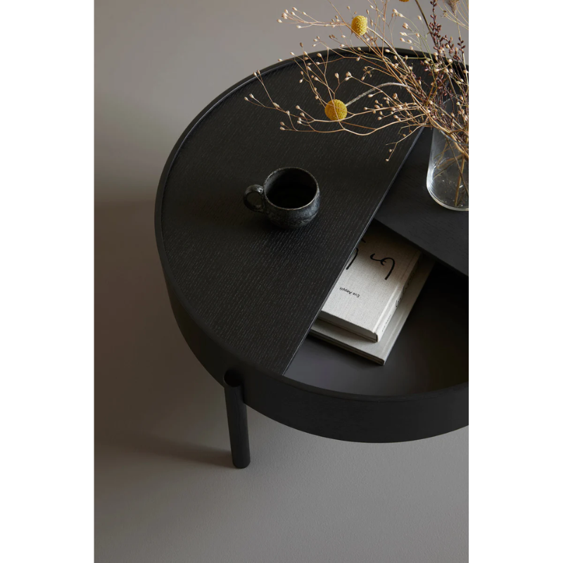 ARC takes its name from the mathematical concept of a smooth curve joining two points in a circle. The ARC table invites its user to make use of the simple functionalities, use one finger to turn the upper tabletop. Let it be open with your favorite objects on display or close the lid to hide your mess. The surface on the inside storage space is covered with a smooth nanolaminate to complement the ash wood while the three-legged construction adds a playful and light touch to the geometric shaped design.