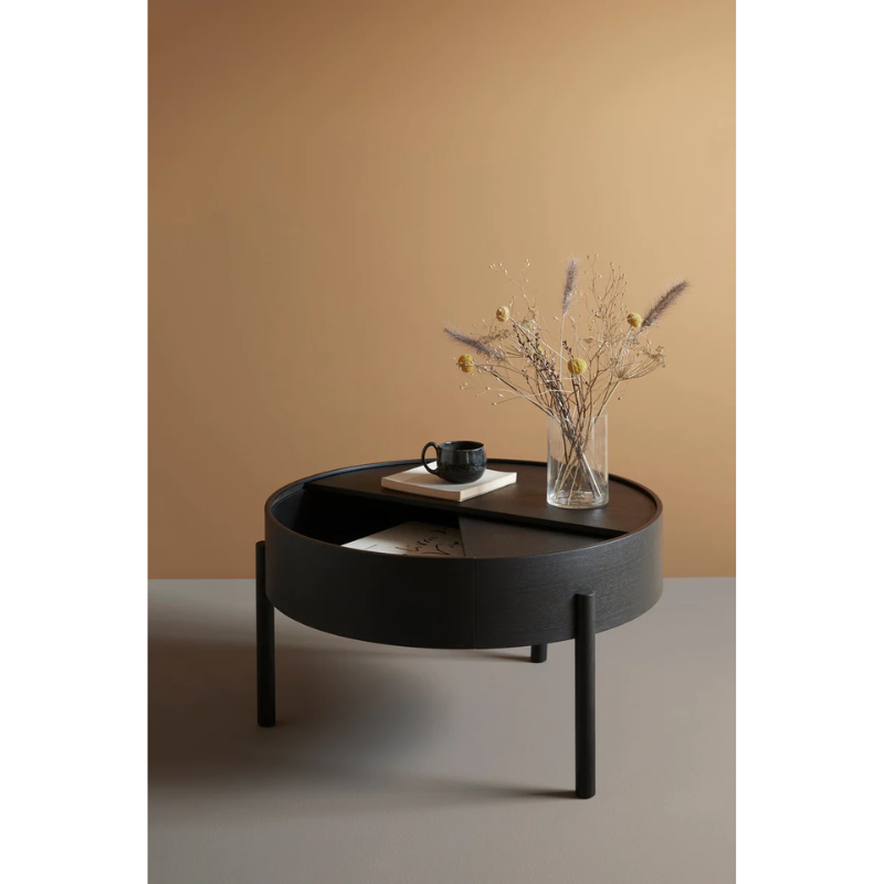 ARC takes its name from the mathematical concept of a smooth curve joining two points in a circle. The ARC table invites its user to make use of the simple functionalities, use one finger to turn the upper tabletop. Let it be open with your favorite objects on display or close the lid to hide your mess. The surface on the inside storage space is covered with a smooth nanolaminate to complement the ash wood while the three-legged construction adds a playful and light touch to the geometric shaped design.