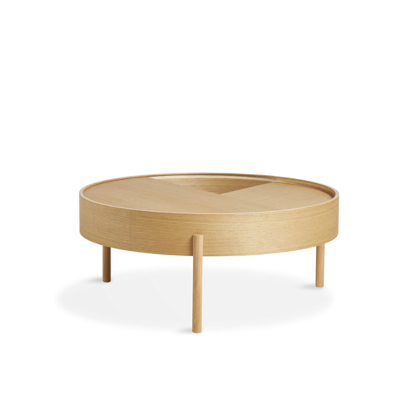 ARC takes its name from the mathematical concept of a smooth curve joining two points in a circle. The ARC table invites its user to make use of the simple functionalities, use one finger to turn the upper tabletop. Let it be open with your favorite objects on display or close the lid to hide your mess. The surface on the inside storage space is covered with a smooth nanolaminate to complement the ash wood while the three-legged construction adds a playful and light touch to the geometric shaped design.