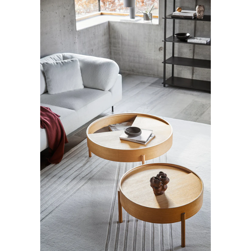 ARC takes its name from the mathematical concept of a smooth curve joining two points in a circle. The ARC table invites its user to make use of the simple functionalities, use one finger to turn the upper tabletop. Let it be open with your favorite objects on display or close the lid to hide your mess. The surface on the inside storage space is covered with a smooth nanolaminate to complement the ash wood while the three-legged construction adds a playful and light touch to the geometric shaped design.
