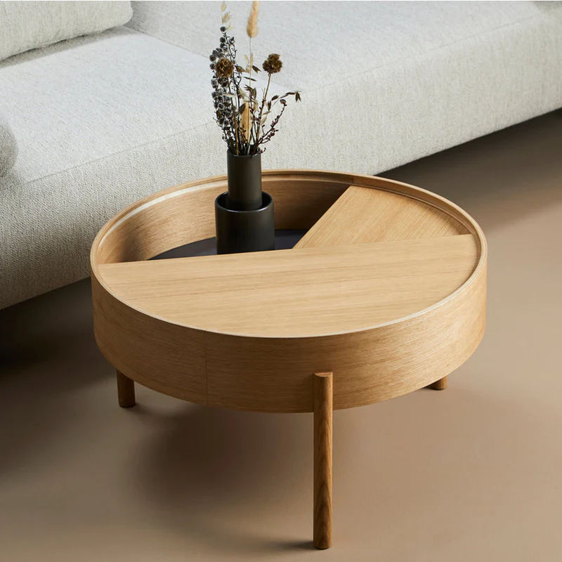 ARC takes its name from the mathematical concept of a smooth curve joining two points in a circle. The ARC table invites its user to make use of the simple functionalities, use one finger to turn the upper tabletop. Let it be open with your favorite objects on display or close the lid to hide your mess. The surface on the inside storage space is covered with a smooth nanolaminate to complement the ash wood while the three-legged construction adds a playful and light touch to the geometric shaped design.