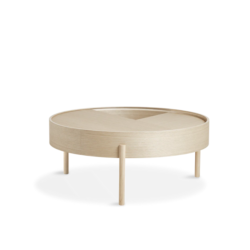 ARC takes its name from the mathematical concept of a smooth curve joining two points in a circle. The ARC table invites its user to make use of the simple functionalities, use one finger to turn the upper tabletop. Let it be open with your favorite objects on display or close the lid to hide your mess. The surface on the inside storage space is covered with a smooth nanolaminate to complement the ash wood while the three-legged construction adds a playful and light touch to the geometric shaped design.