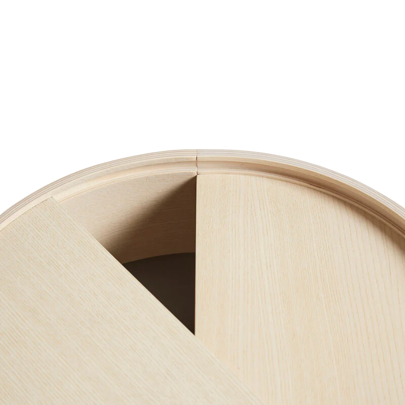 ARC takes its name from the mathematical concept of a smooth curve joining two points in a circle. The ARC table invites its user to make use of the simple functionalities, use one finger to turn the upper tabletop. Let it be open with your favorite objects on display or close the lid to hide your mess. The surface on the inside storage space is covered with a smooth nanolaminate to complement the ash wood while the three-legged construction adds a playful and light touch to the geometric shaped design.