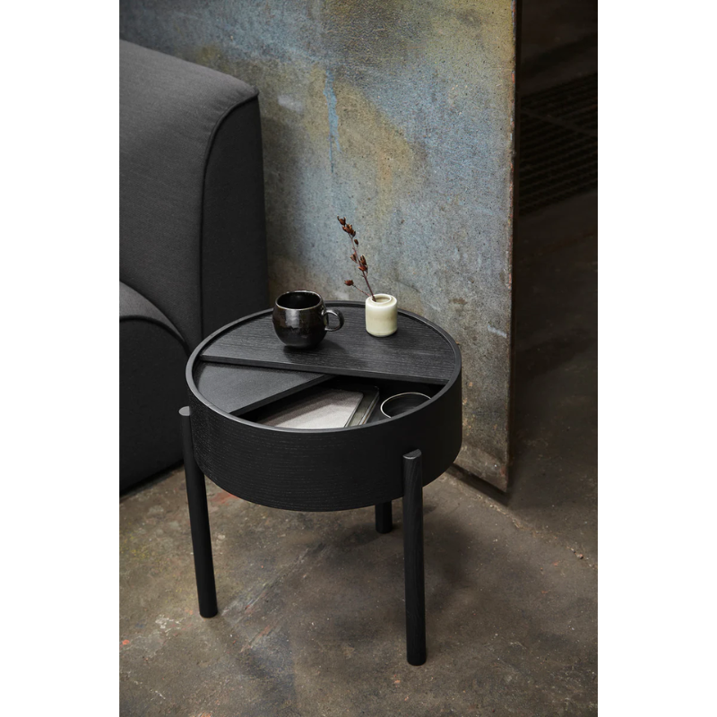 ARC takes its name from the mathematical concept of a smooth curve joining two points in a circle. The ARC table invites its user to make use of the simple functionalities, use one finger to turn the upper tabletop. Let it be open with your favorite objects on display or close the lid to hide your mess. The surface on the inside storage space is covered with a smooth nanolaminate to complement the ash wood while the three-legged construction adds a playful and light touch to the geometric shaped design.