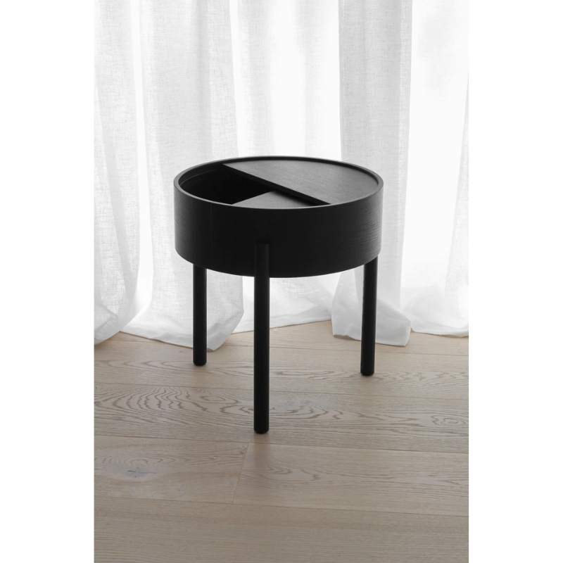 ARC takes its name from the mathematical concept of a smooth curve joining two points in a circle. The ARC table invites its user to make use of the simple functionalities, use one finger to turn the upper tabletop. Let it be open with your favorite objects on display or close the lid to hide your mess. The surface on the inside storage space is covered with a smooth nanolaminate to complement the ash wood while the three-legged construction adds a playful and light touch to the geometric shaped design.