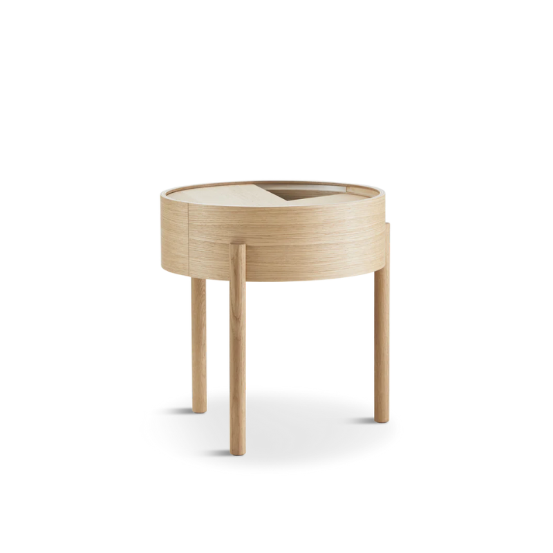 ARC takes its name from the mathematical concept of a smooth curve joining two points in a circle. The ARC table invites its user to make use of the simple functionalities, use one finger to turn the upper tabletop. Let it be open with your favorite objects on display or close the lid to hide your mess. The surface on the inside storage space is covered with a smooth nanolaminate to complement the ash wood while the three-legged construction adds a playful and light touch to the geometric shaped design.