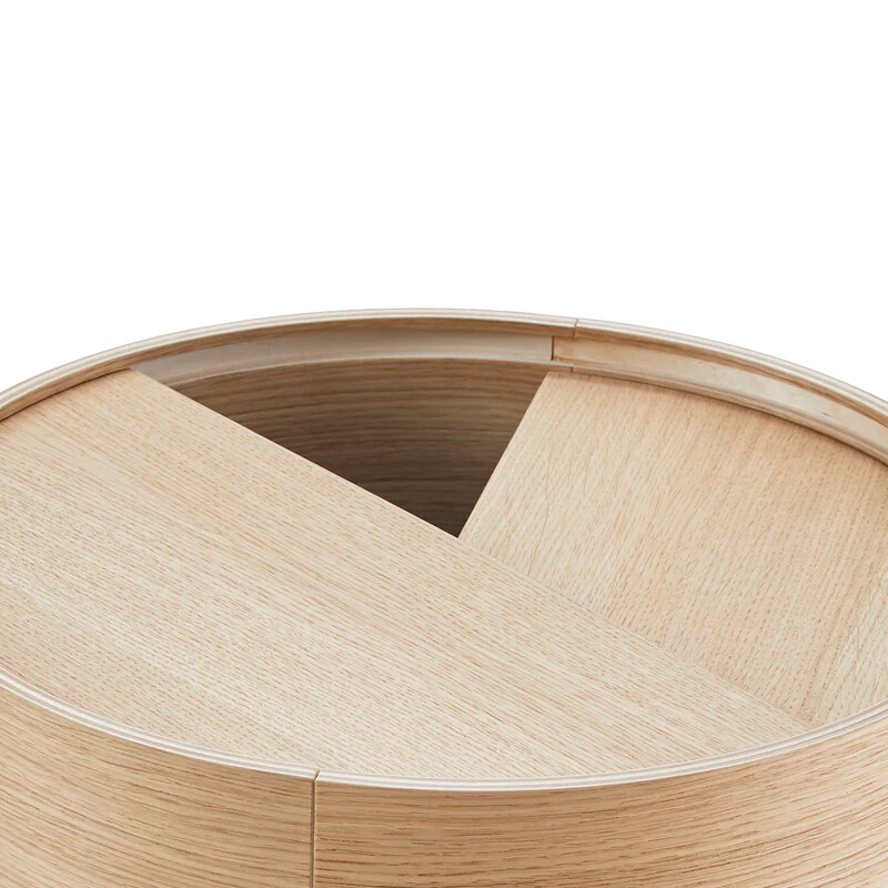ARC takes its name from the mathematical concept of a smooth curve joining two points in a circle. The ARC table invites its user to make use of the simple functionalities, use one finger to turn the upper tabletop. Let it be open with your favorite objects on display or close the lid to hide your mess. The surface on the inside storage space is covered with a smooth nanolaminate to complement the ash wood while the three-legged construction adds a playful and light touch to the geometric shaped design.