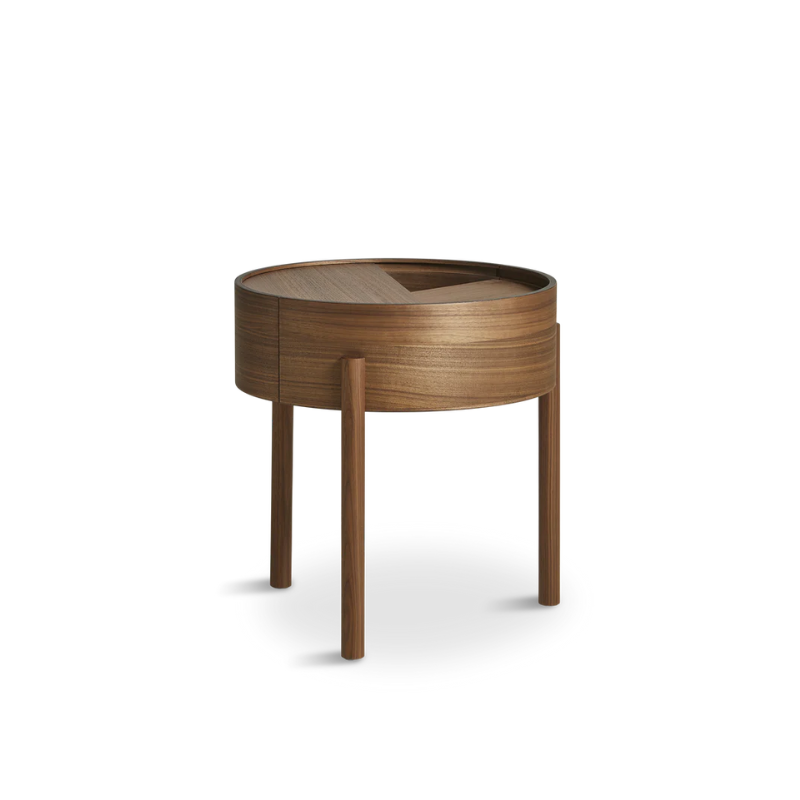 ARC takes its name from the mathematical concept of a smooth curve joining two points in a circle. The ARC table invites its user to make use of the simple functionalities, use one finger to turn the upper tabletop. Let it be open with your favorite objects on display or close the lid to hide your mess. The surface on the inside storage space is covered with a smooth nanolaminate to complement the ash wood while the three-legged construction adds a playful and light touch to the geometric shaped design.