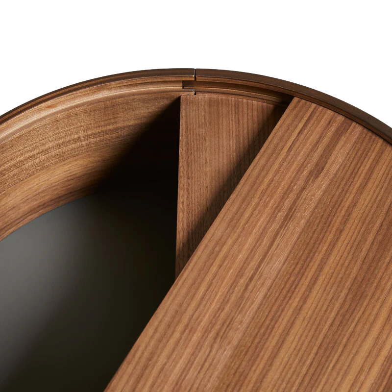 ARC takes its name from the mathematical concept of a smooth curve joining two points in a circle. The ARC table invites its user to make use of the simple functionalities, use one finger to turn the upper tabletop. Let it be open with your favorite objects on display or close the lid to hide your mess. The surface on the inside storage space is covered with a smooth nanolaminate to complement the ash wood while the three-legged construction adds a playful and light touch to the geometric shaped design.