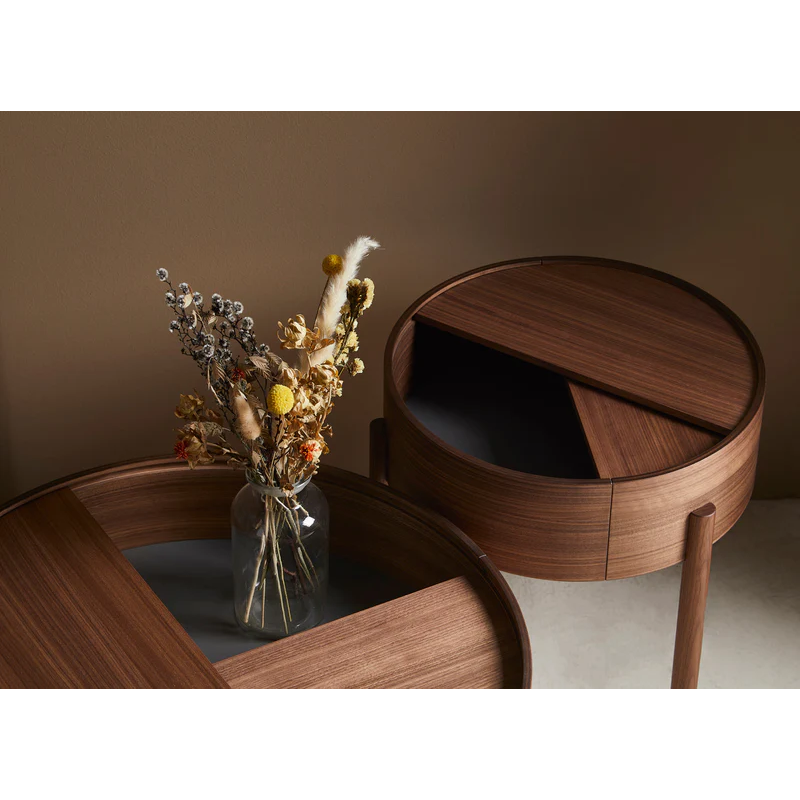 ARC takes its name from the mathematical concept of a smooth curve joining two points in a circle. The ARC table invites its user to make use of the simple functionalities, use one finger to turn the upper tabletop. Let it be open with your favorite objects on display or close the lid to hide your mess. The surface on the inside storage space is covered with a smooth nanolaminate to complement the ash wood while the three-legged construction adds a playful and light touch to the geometric shaped design.