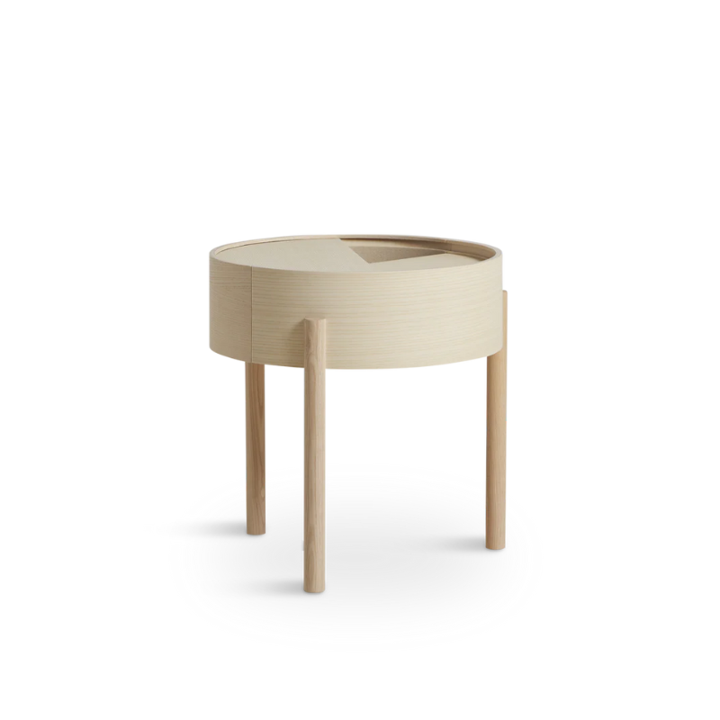 ARC takes its name from the mathematical concept of a smooth curve joining two points in a circle. The ARC table invites its user to make use of the simple functionalities, use one finger to turn the upper tabletop. Let it be open with your favorite objects on display or close the lid to hide your mess. The surface on the inside storage space is covered with a smooth nanolaminate to complement the ash wood while the three-legged construction adds a playful and light touch to the geometric shaped design.