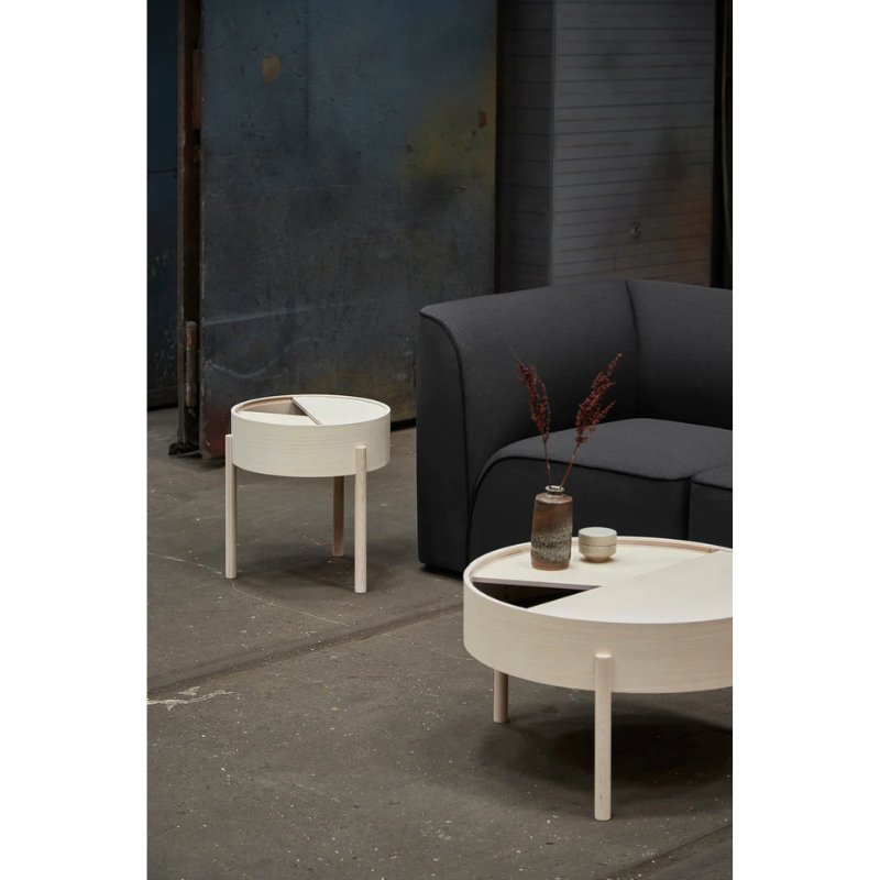 ARC takes its name from the mathematical concept of a smooth curve joining two points in a circle. The ARC table invites its user to make use of the simple functionalities, use one finger to turn the upper tabletop. Let it be open with your favorite objects on display or close the lid to hide your mess. The surface on the inside storage space is covered with a smooth nanolaminate to complement the ash wood while the three-legged construction adds a playful and light touch to the geometric shaped design.