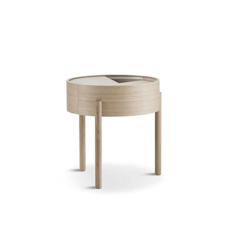 ARC takes its name from the mathematical concept of a smooth curve joining two points in a circle. The ARC table invites its user to make use of the simple functionalities, use one finger to turn the upper tabletop. Let it be open with your favorite objects on display or close the lid to hide your mess. The surface on the inside storage space is covered with a smooth nanolaminate to complement the ash wood while the three-legged construction adds a playful and light touch to the geometric shaped design.
