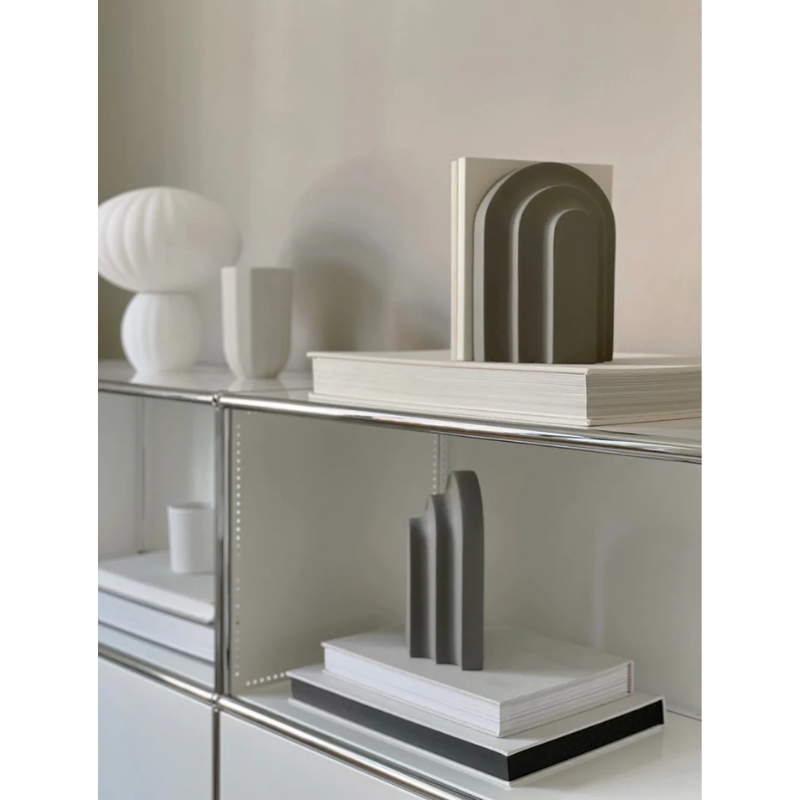 Together with a row of books Arkiv forms a small graphic ensemble of arches and blocks. Inspired by the function and aesthetic of the classic architectural arches and columns. With its vivid shape, the bookend catches the light and throws harmonious shadows revealing a fascinating and delightful piece to the eye. Lean your favourite books against Arkiv, lay it horizontal to function as a paper press or use it as a decorative piece of art.