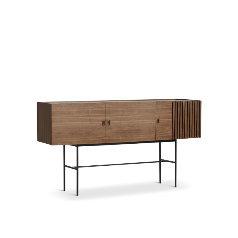 The Array series is inspired by the wooden slate cladding found in modern architecture. With its geometric shape and horizontal slats, it creates a strong visual effect from catching both light and shadow in the depth of the slats. The sleek legs lift the sideboards from the ground creating an elegant contrast between the solid wooden cabinet on top and the thin metal construction underneath. Soft closing doors make the cabinet both functional and delicate.