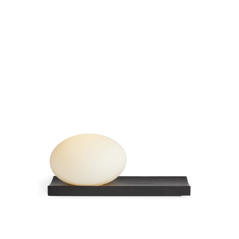 With its portable character, the versatile piece functions as a dynamic table and wall lamp. At the same time, its dimmable feature allows you to change the mood and intensity of the light to suit the specific setting. Place it on a desk, use the tray for your pieces of jewelry or hang it on the wall to provide an inviting light with no need for an electrical supply.