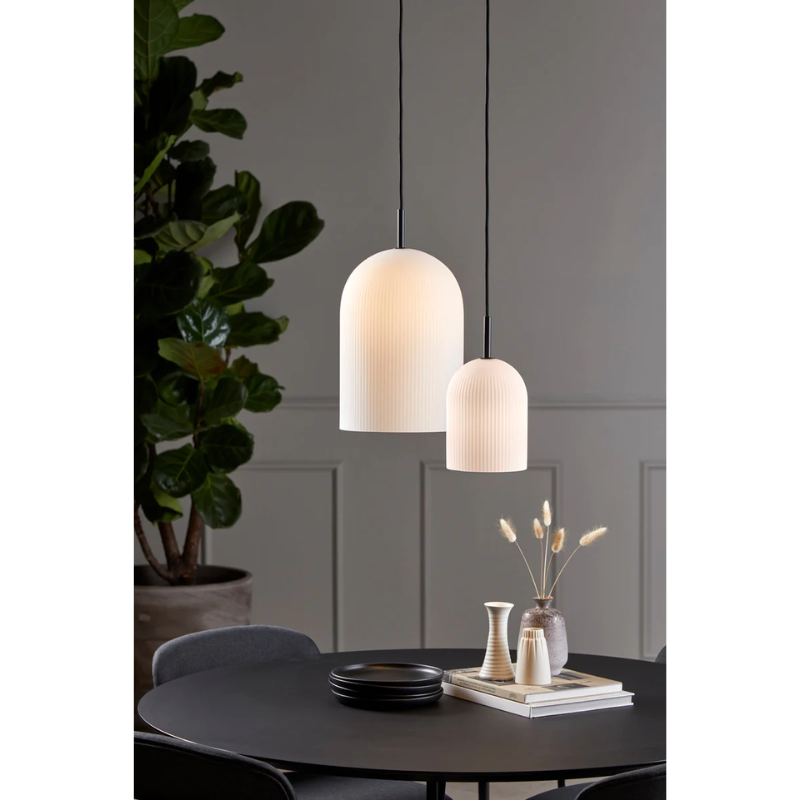 With its sculptural and minimalistic refined silhouette, the Ghost pendant has a modern purity. Made of translucent opal glass, the shade gives an illusion of a white cloth thrown over the light source. Resembling the appearance of a friendly ghost in the air. A figure that is enhanced by the subtle vertical groove pattern fading out gradually upwards. Casting a soft, diffused light, the Ghost pendant will fill the room with a cozy vibe.