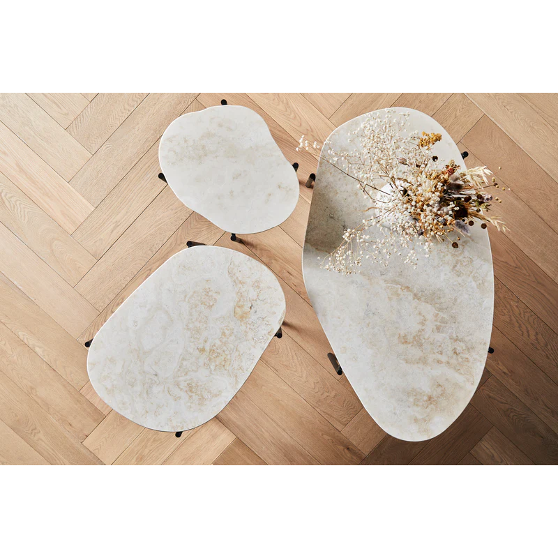 Made from travertine, every surface is unique as the play of colors varies in the natural material. With three different available sizes and heights, the table can be placed as a single piece or entire landscapes can be created.