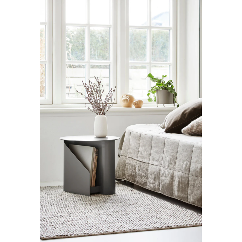 The Sentrum side table follows the principle of simplicity as it has been stripped from all unnecessary elements. What is left is a strong base and geometrical expression with pure functionalities. The S-shaped construction makes the center of attention and creates two spaces for storage on both sides to enhance the usability of the side table - ideal for magazines and books.