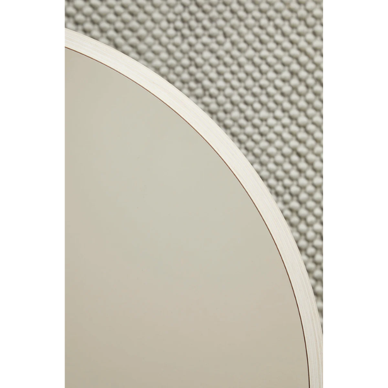 A close up on the Soround Coffee Table from Woud to show off the beige color.