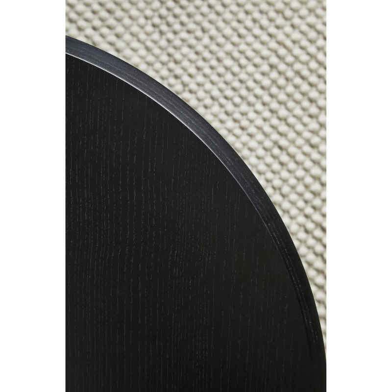 A close up on the Soround Coffee Table from Woud to show off the black ash color.