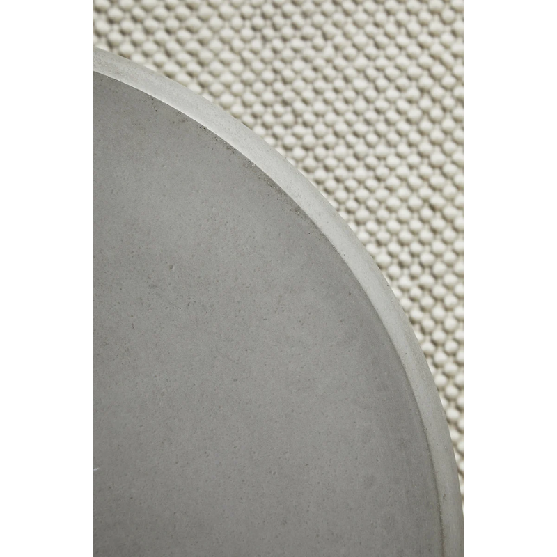 A close up on the Soround Coffee Table from Woud to show off the concrete color.