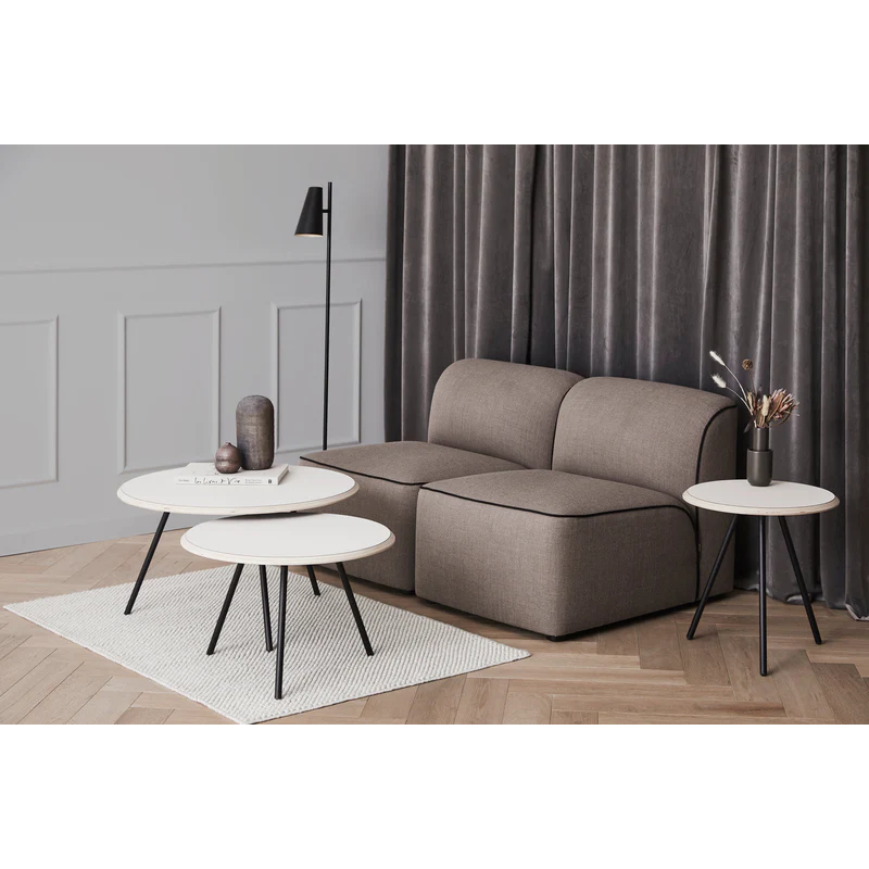 Two beige Soround Coffee Tables from Woud being used in an office-like setting.