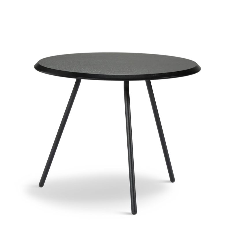 The Soround Coffee Table from Woud with the small diameter table top and high height in black ash.