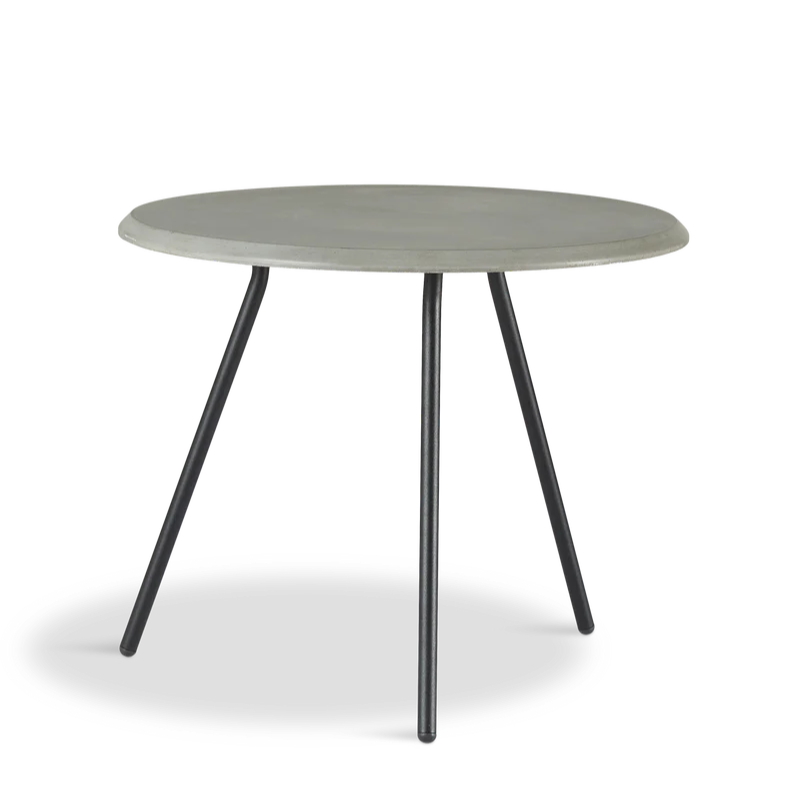 The Soround Coffee Table from Woud with the small diameter table top and high height in concrete.