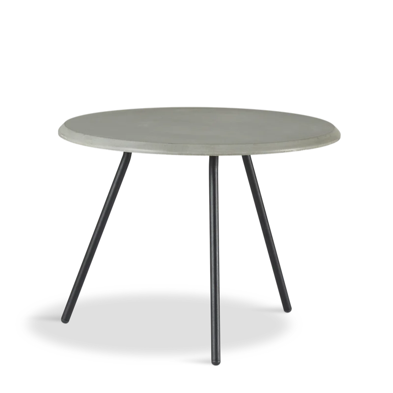 The Soround Coffee Table from Woud with the small diameter table top and medium height in concrete.