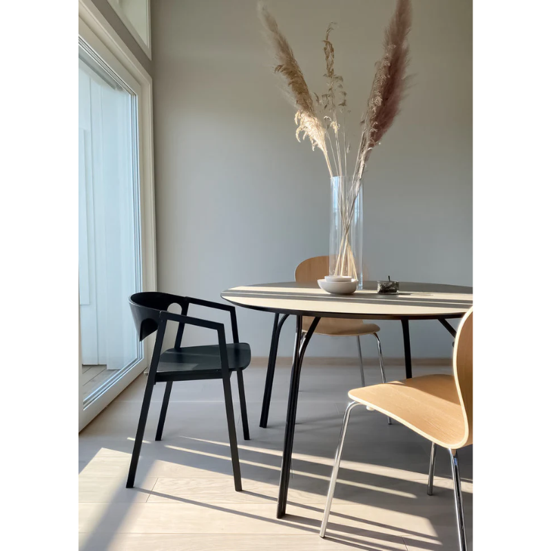 The Tree Dining Table from Woud in beige and black with other decor and Woud products.