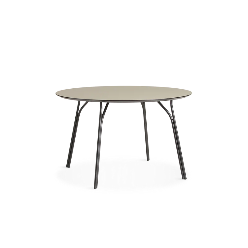A medium Tree Dining Table from Woud in beige and black.