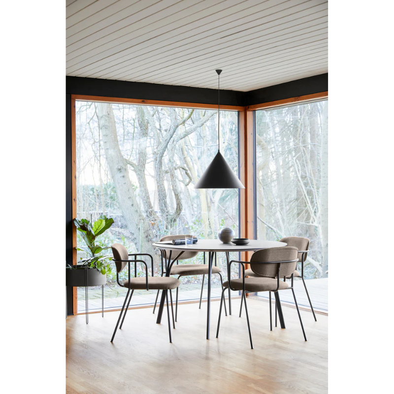 The beige Tree Dining Table in an open space dining area.
