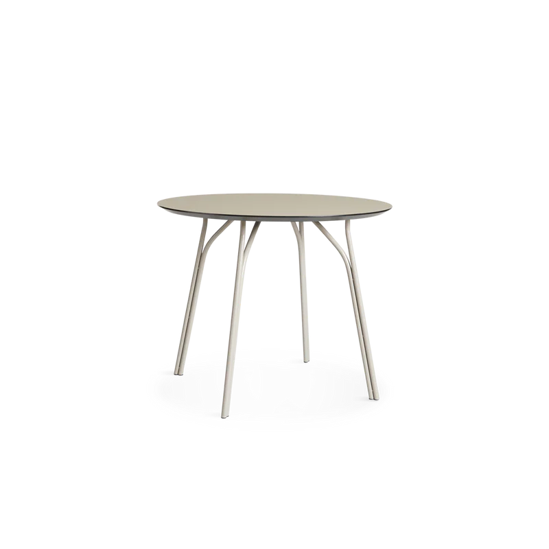A small Tree Dining Table from Woud in beige.