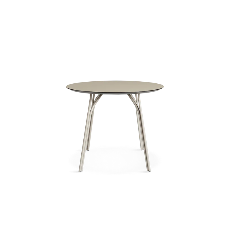 A small Tree Dining Table from Woud in beige and black from a new angle.