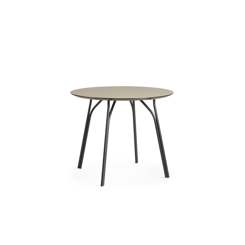 A small Tree Dining Table from Woud in beige and black.