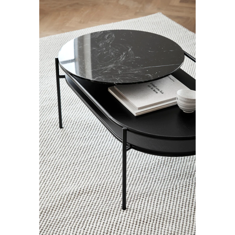 The Verde Coffee Table from Woud with the Black Marble tabletop in a family space.