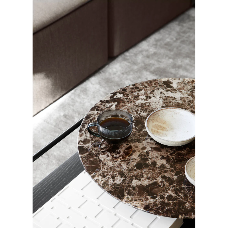 The Verde Coffee Table from Woud with the Brown Marble tabletop being used as a coffee table.