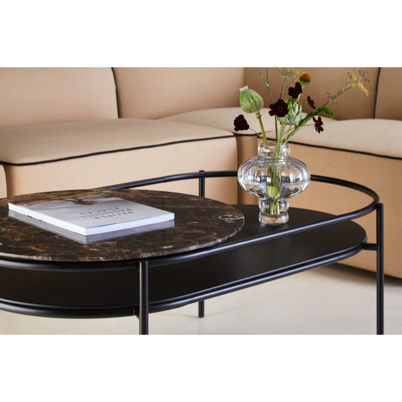 The Verde Coffee Table from Woud with the Brown Marble tabletop in a living room.
