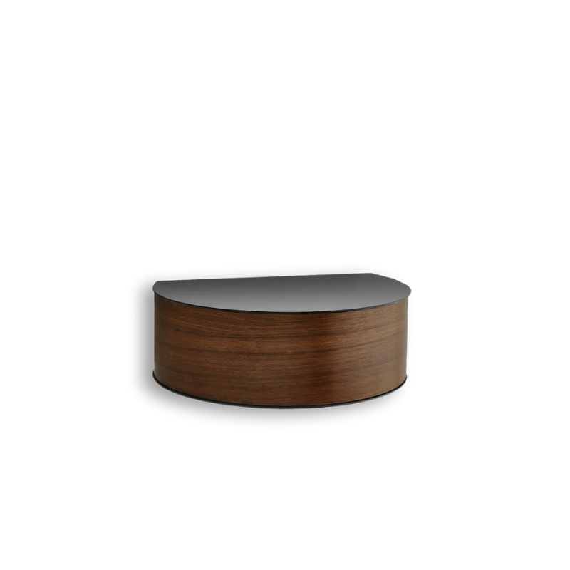 Wallie beautifully combines bent walnut with solid black metal creating an elegant wall-mounted drawer. With its circular, soft shapes Wallie is a visually strong design that easily can act as a centerpiece or be combined with other designs. The bracket embraces the magnetic wood drawer making the design both minimalistic and functional. Wallie is perfect for storing small everyday essentials in the hallway or as a bedside table in the bedroom.