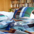 The Antoni Throw from the Wallace & Sewell Block Throw Collection is inspired by Korean artist, Chung Eun Mo's abstract paintings. This stunning throw features a bold checkerboard pattern of juxtaposed blocks and striking hues. Made from sumptuous merino lambswool and finished with blanket stitches for added elegance, the Antoni Throw is reversible with a different colorway on each side. 