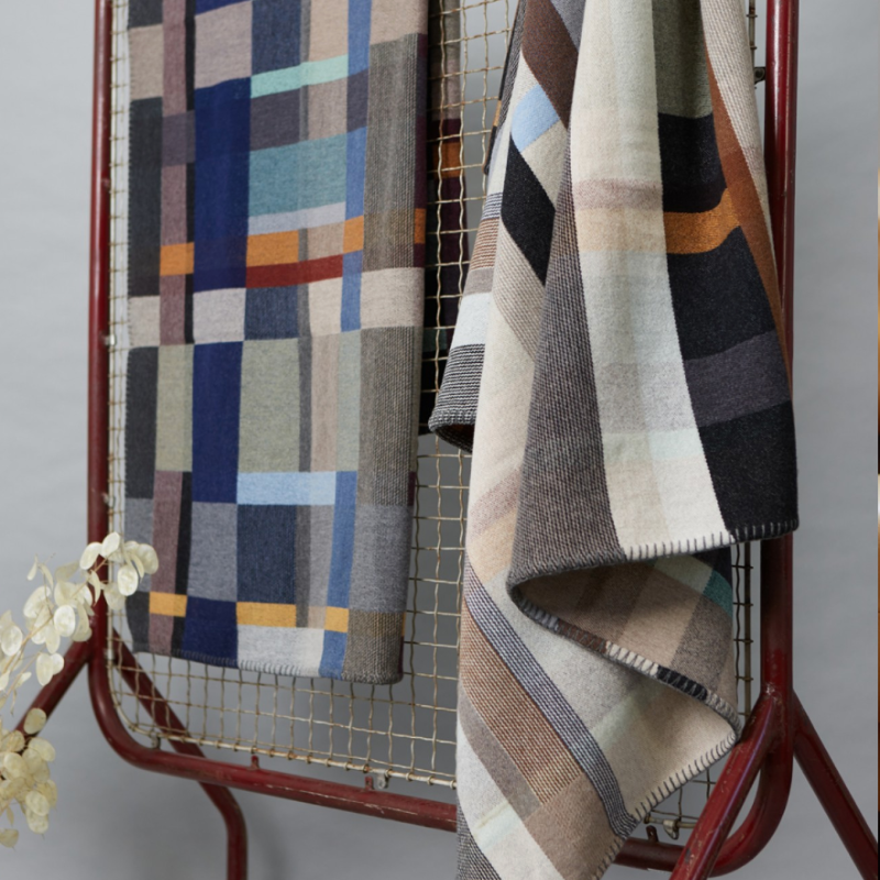 The Chipperfield Throw from the Wallace & Sewell Block Throw Collection is inspired by Korean artist, Chung Eun Mo's abstract paintings. This stunning throw features a bold checkerboard pattern of juxtaposed blocks and striking hues. Made from sumptuous merino lambswool and finished with blanket stitches for added elegance, the Chipperfield Throw is reversible with a different colorway on each side. 